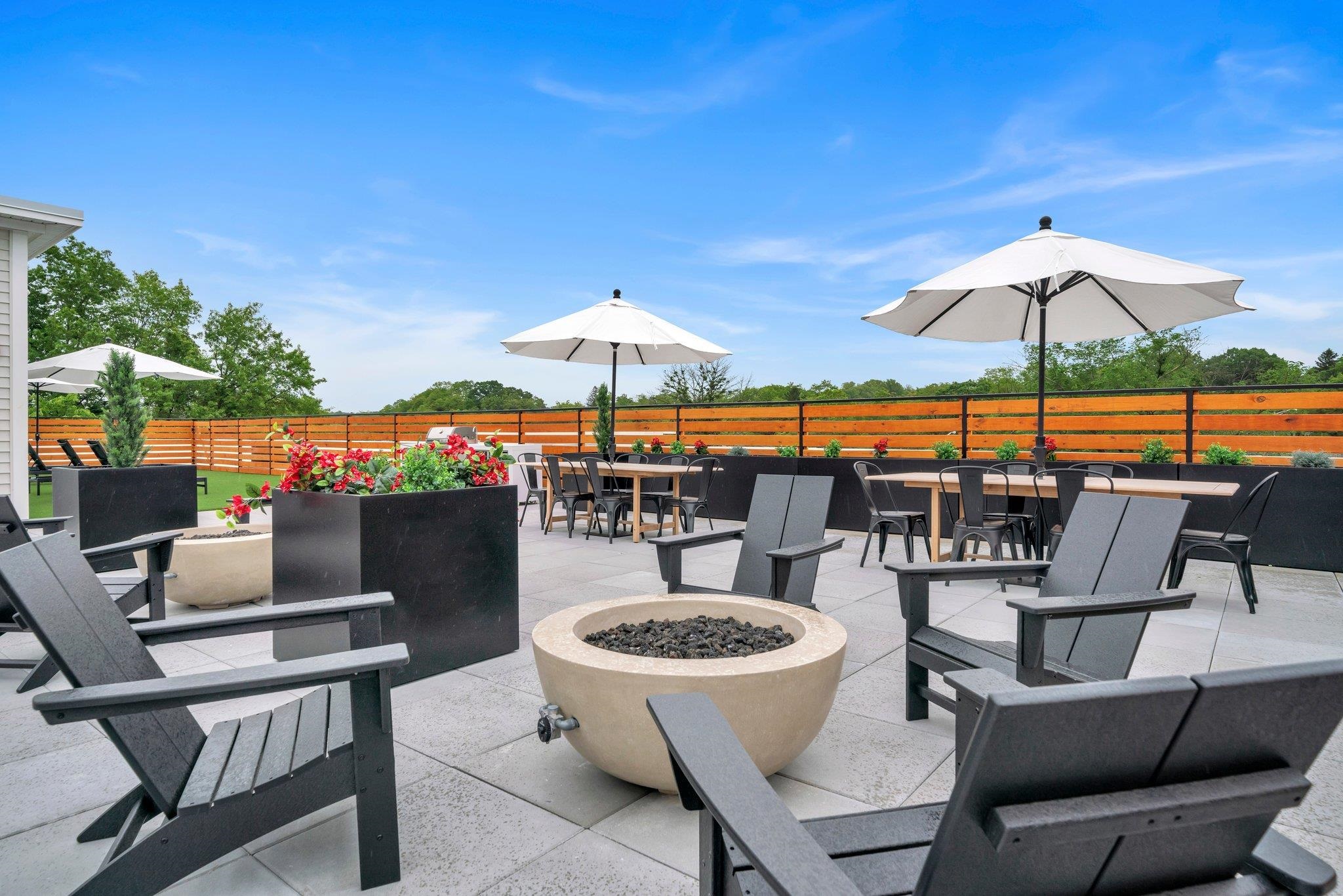 a view of a terrace with furniture and umbrella