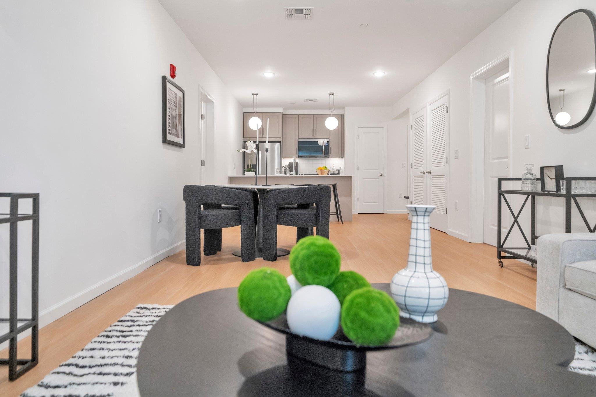 74 Ridgedale Avenue, Unit 304 Morristown, NJ 07960 - Photo 12 of 42 a living room with furniture a potted plant and a chandelier