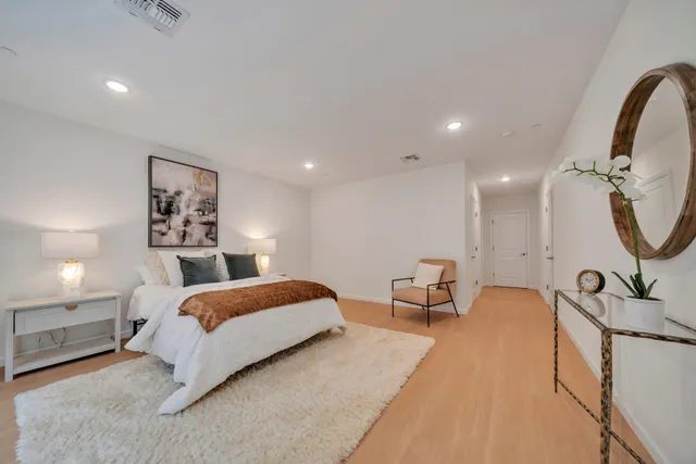 a bedroom with a bed and glass walk in closet