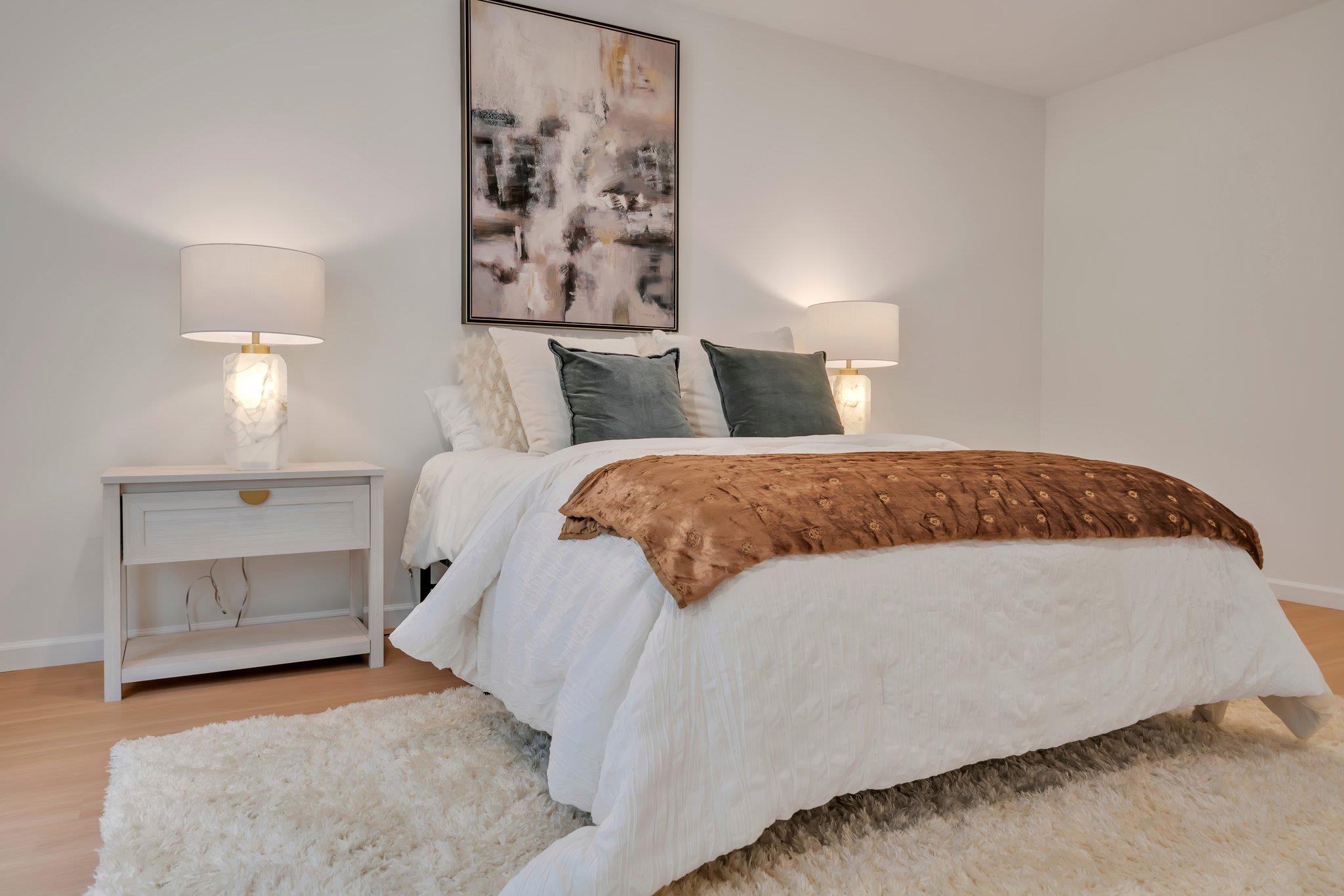74 Ridgedale Avenue, Unit 304 Morristown, NJ 07960 - Photo 18 of 42 a bedroom with a bed and a lamp on dresser