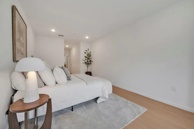 a bedroom with a bed and a chair