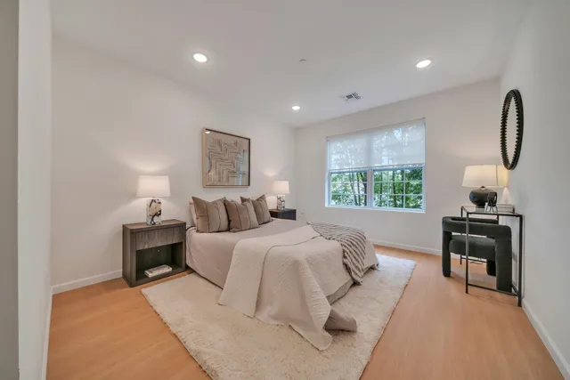 a bed room with a bed and a lamp