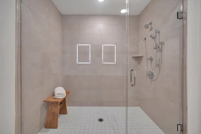 a bathroom with a double vanity sink mirror and shower