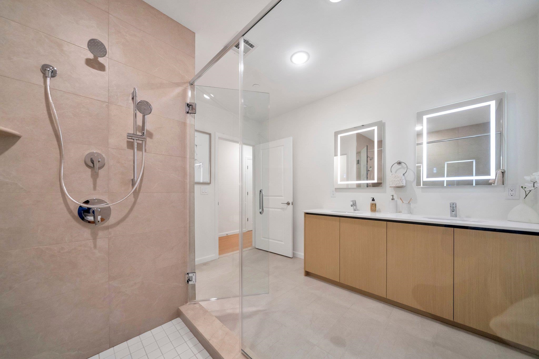 74 Ridgedale Avenue, Unit 304 Morristown, NJ 07960 - Photo 24 of 42 a bathroom with a double vanity sink mirror and shower