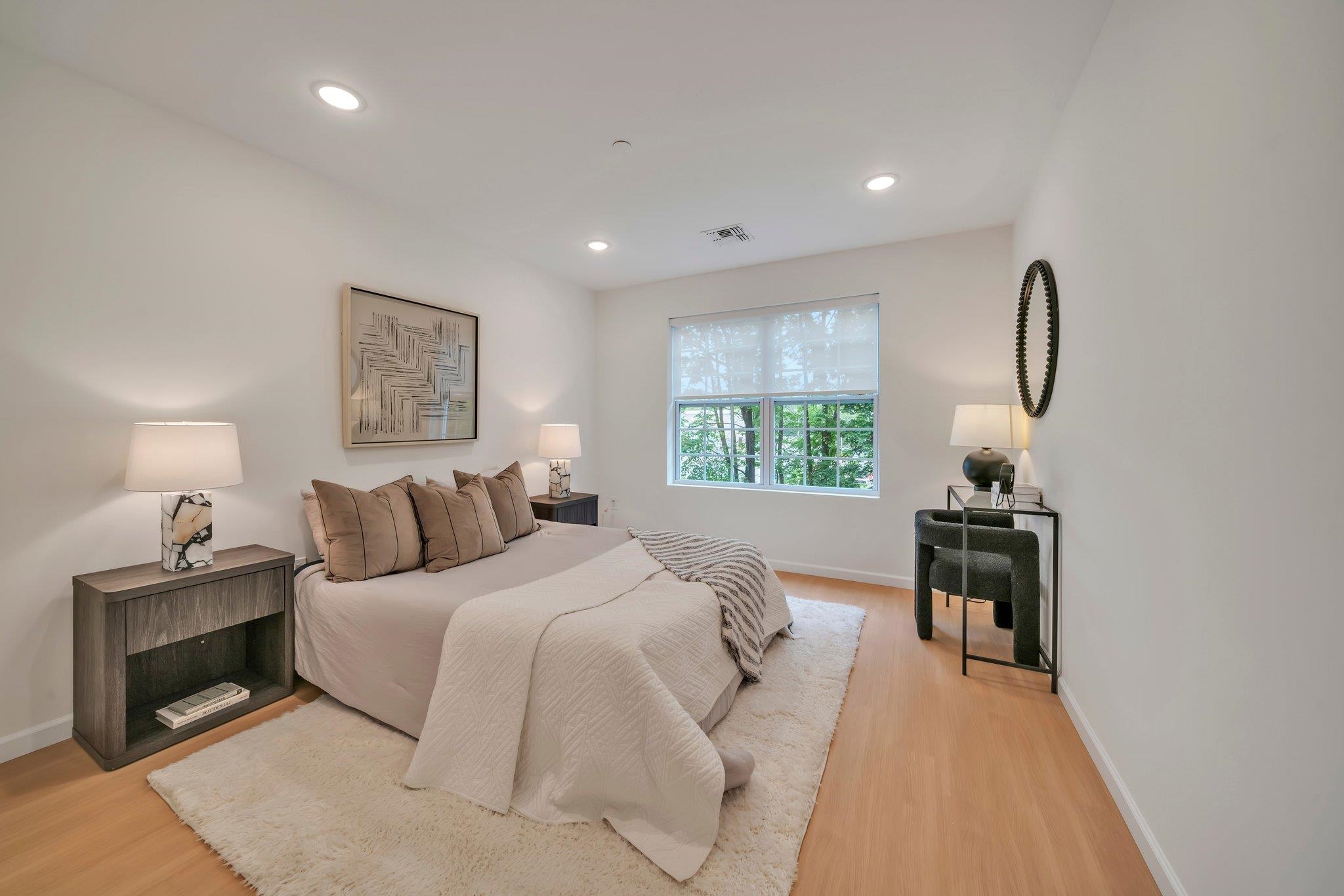 74 Ridgedale Avenue, Unit 304 Morristown, NJ 07960 - Photo 25 of 42 a bedroom with a bed and a lamp