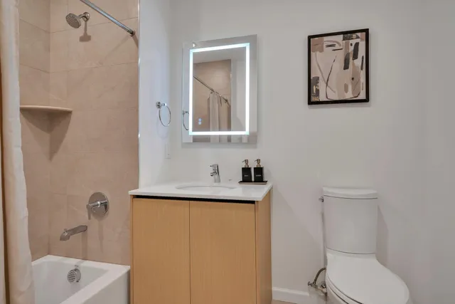 a bathroom with a shower sink and mirror