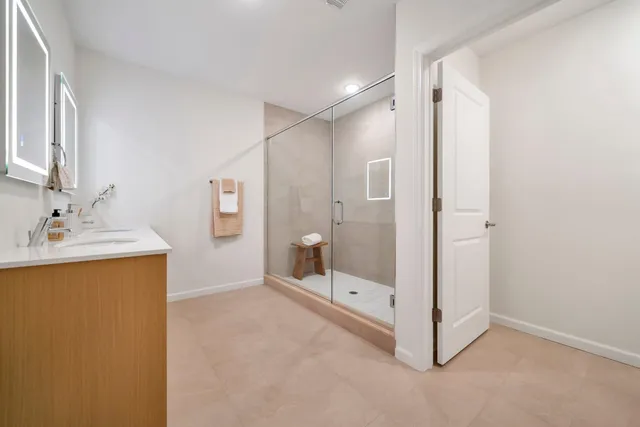a bathroom with double vanity sinks and a mirror