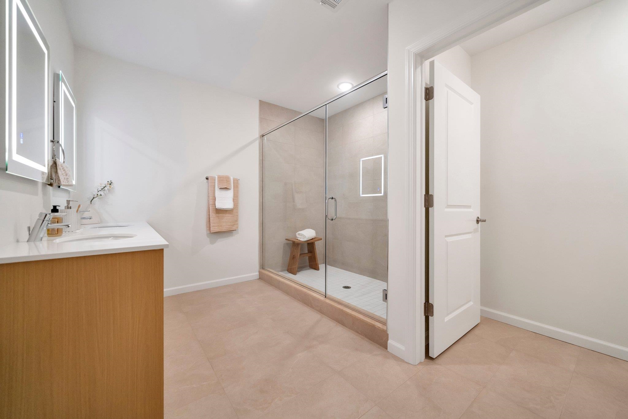 74 Ridgedale Avenue, Unit 304 Morristown, NJ 07960 - Photo 28 of 42 a bathroom with a shower sink and mirror