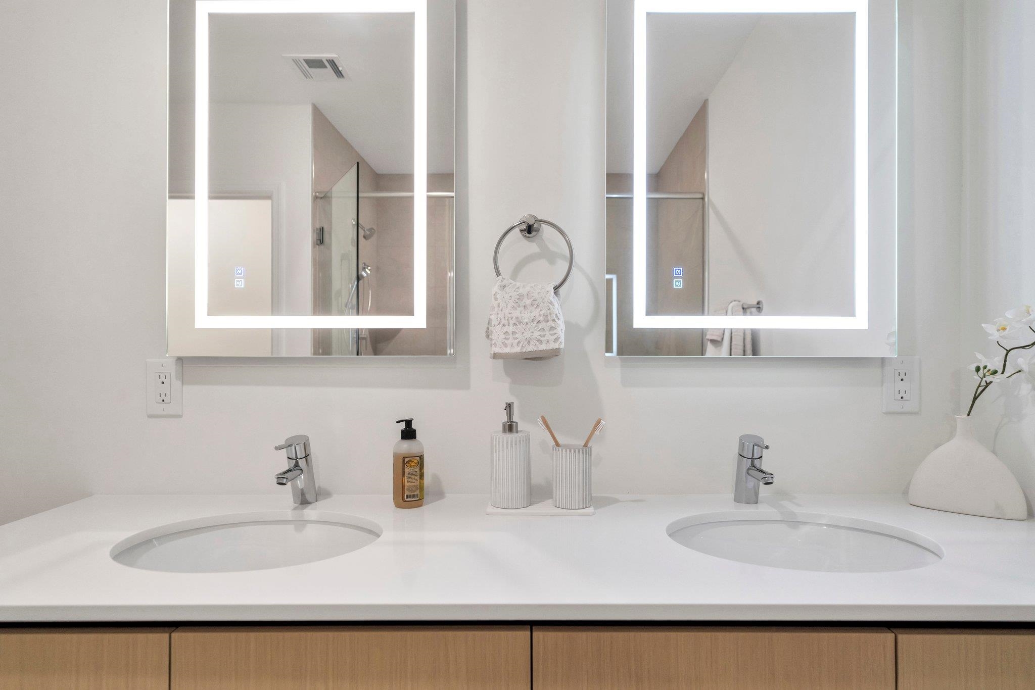 74 Ridgedale Avenue, Unit 304 Morristown, NJ 07960 - Photo 29 of 42 a bathroom with double vanity sinks and a mirror