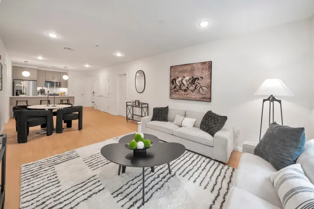 a living room with furniture and wooden floor