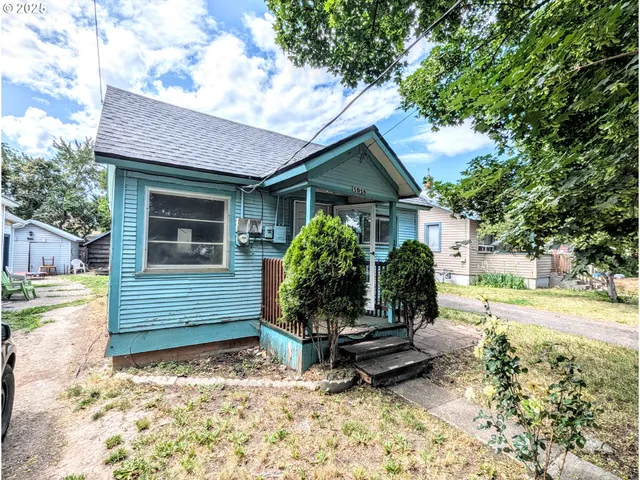 a view of a house with a yard and sitting area