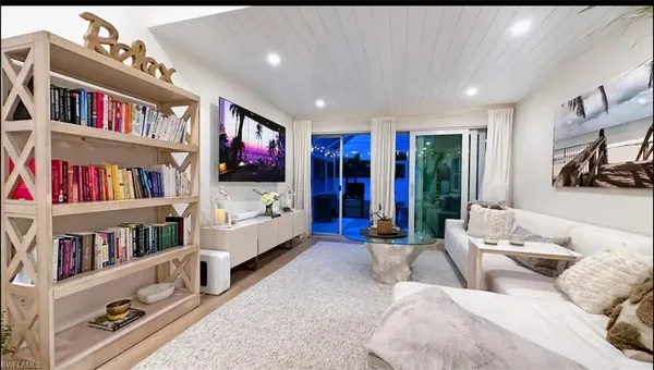 a living room with furniture and a book shelf