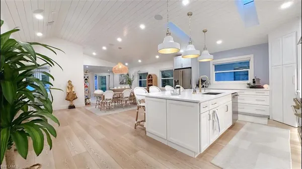 a large white kitchen with lots of counter space
