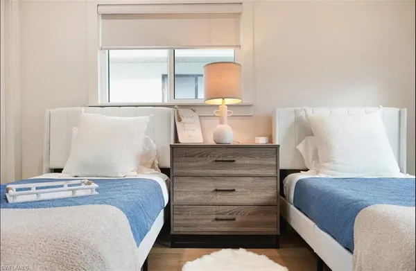 a bedroom with a bed and a mirror