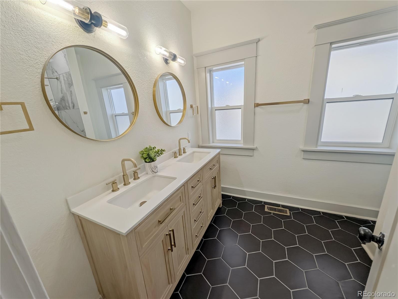 710 Carson Street Brush, CO 80723 - Photo 13 of 30 a bathroom with a double vanity sink mirror and