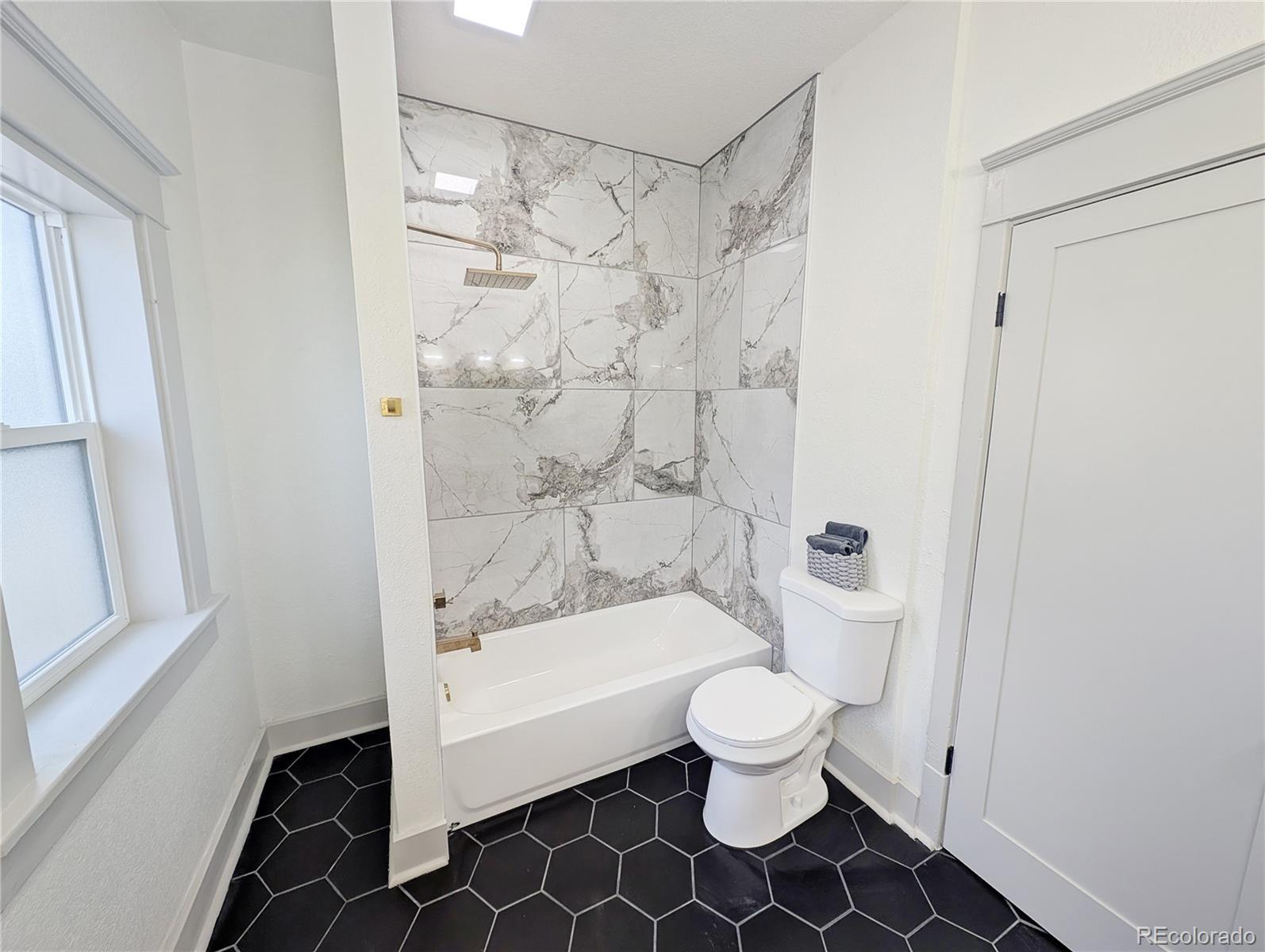 710 Carson Street Brush, CO 80723 - Photo 14 of 30 a bathroom with a toilet and a shower