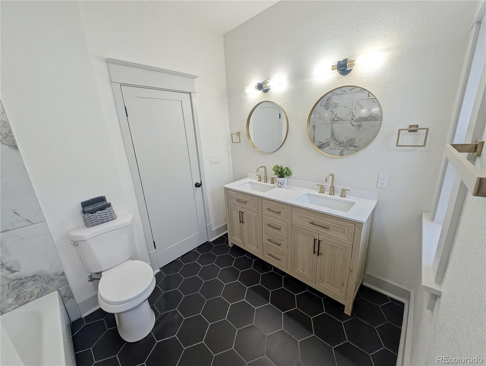 710 Carson Street Brush, CO 80723 - Photo 15 of 30 a bathroom with a double vanity sink mirror and toilet