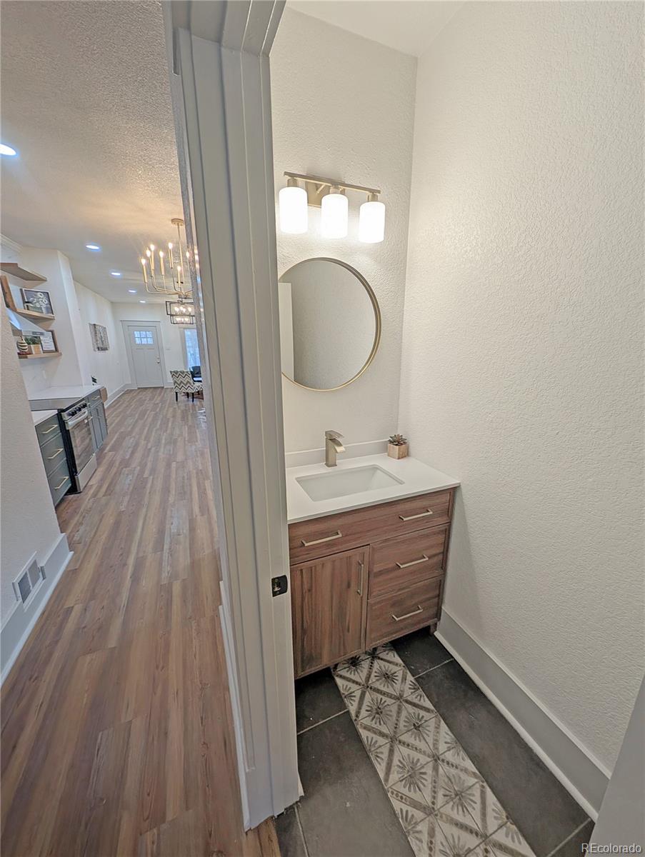710 Carson Street Brush, CO 80723 - Photo 19 of 30 a bathroom with a vanity mirror and sink