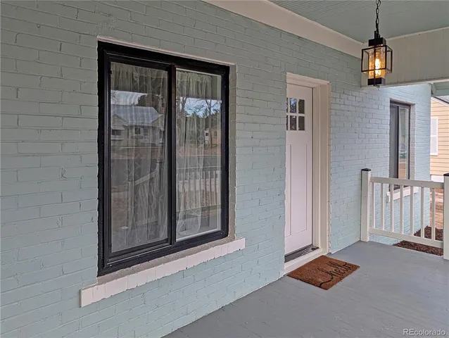 a view of a house with a yard and large tree