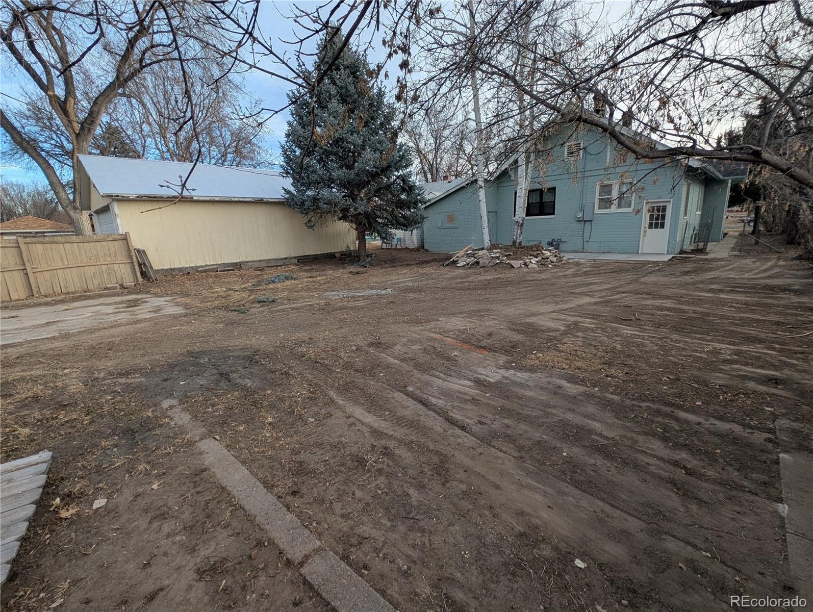 710 Carson Street Brush, CO 80723 - Photo 30 of 30 a view of house with yard and trees in the background