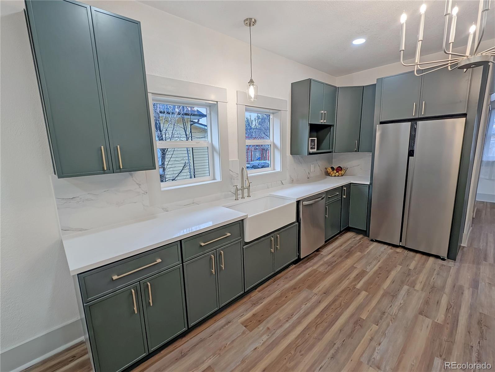 710 Carson Street Brush, CO 80723 - Photo 3 of 30 a kitchen with stainless steel appliances a sink cabinets and wooden floor