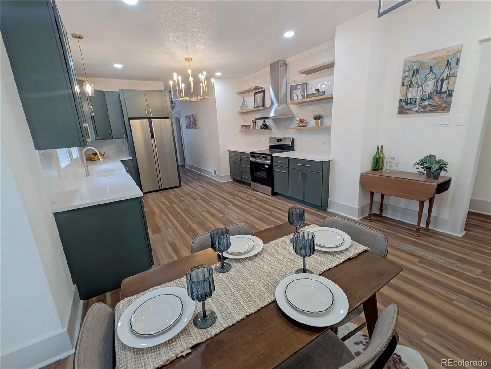710 Carson Street Brush, CO 80723 - Photo 5 of 30 a kitchen with stainless steel appliances a dining table and chairs