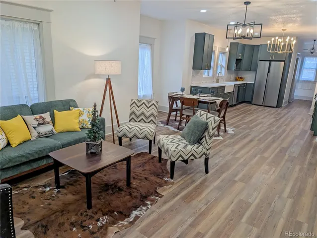 a living room with furniture and a chandelier