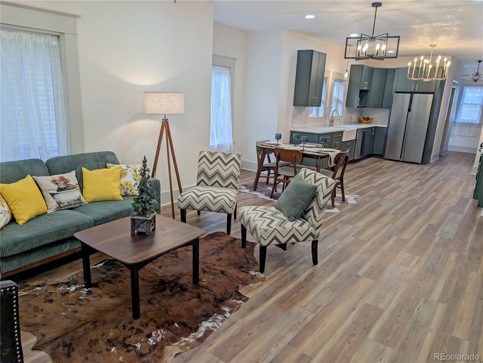 710 Carson Street Brush, CO 80723 - Photo 7 of 30 a living room with furniture and a chandelier
