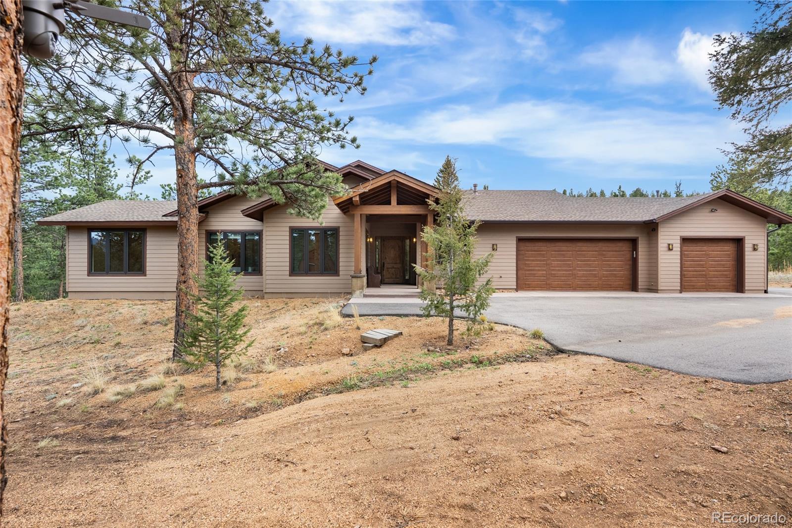 280 Double Tree Road Bailey, CO 80421 - Photo 4 of 43 front view of a house with a dry yard