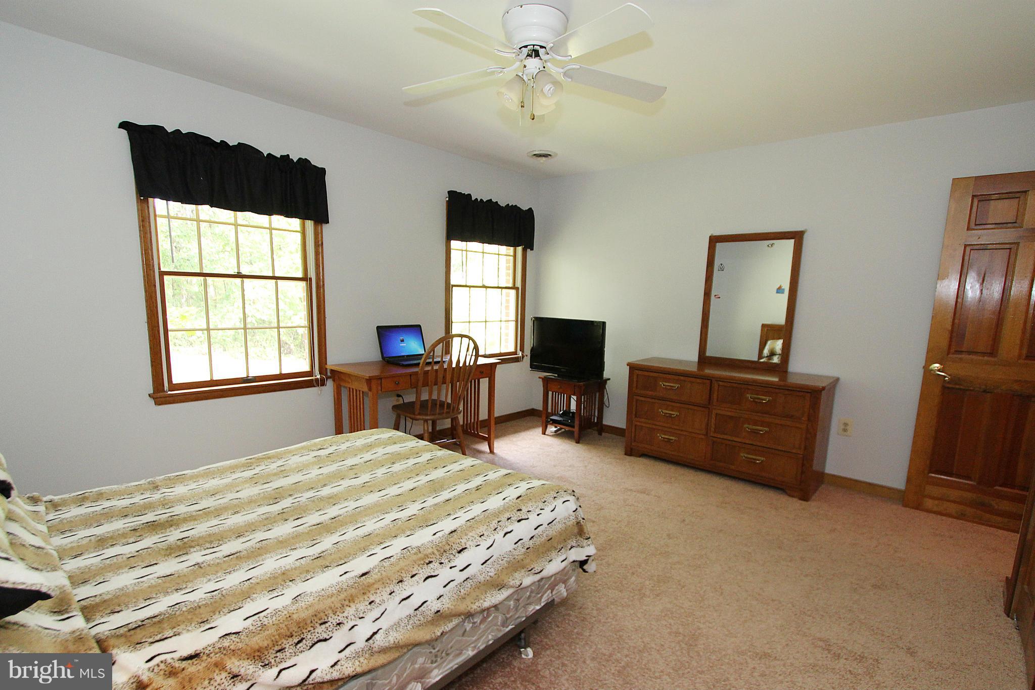 3154 Charles Street Fallston, MD 21047 - Photo 23 of 30 a bedroom with a bed and a flat tv screen on dresser