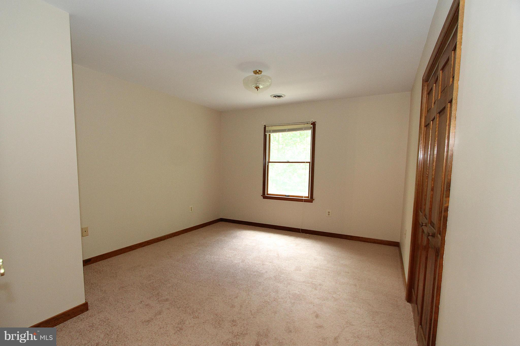 3154 Charles Street Fallston, MD 21047 - Photo 9 of 30 an empty room with a window and a ceiling fan