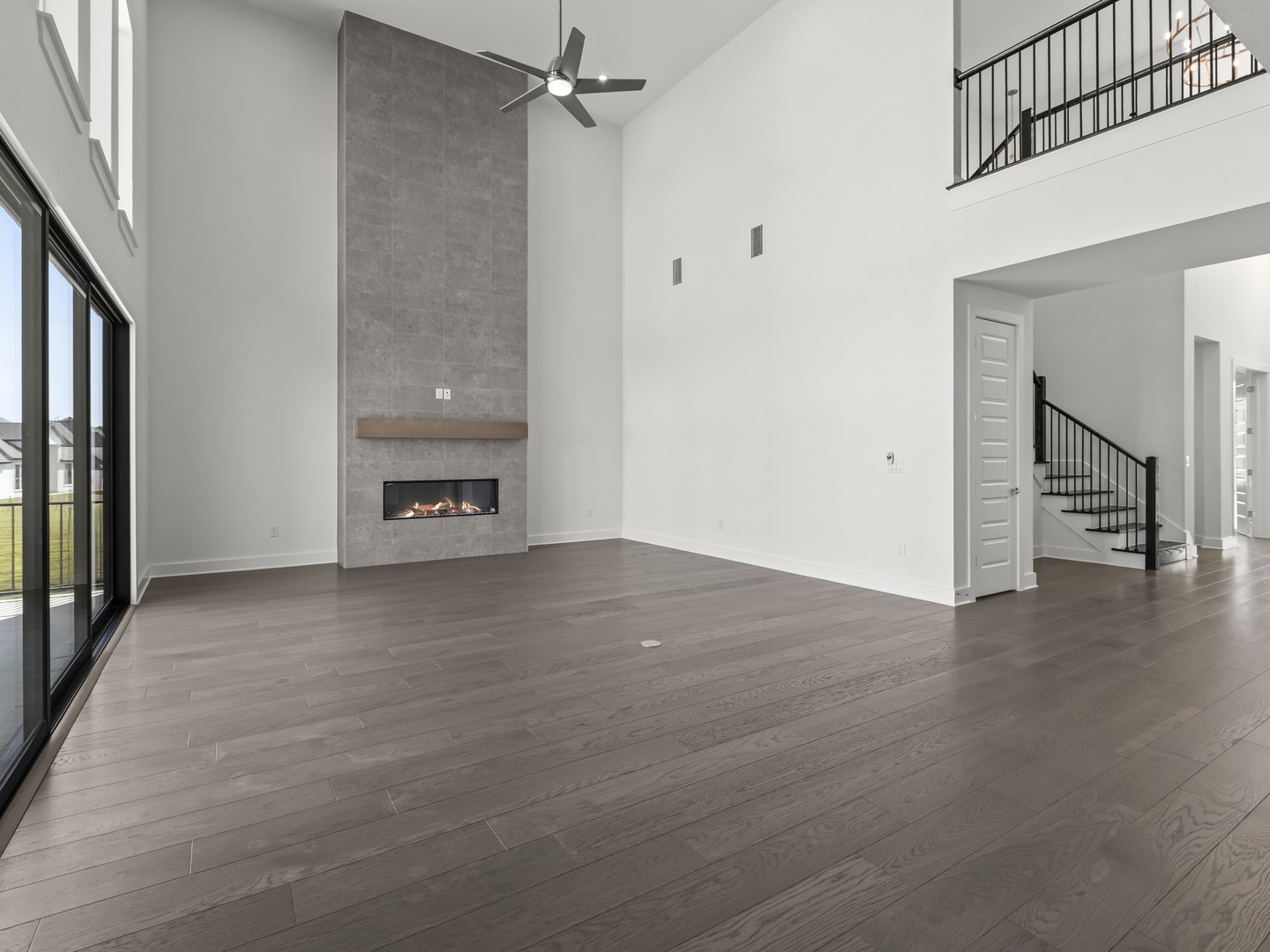 2508 Chiavari Way Leander, TX 78641 - Photo 7 of 24 A spacious living area with soaring ceilings and a contemporary fireplace feature wall.