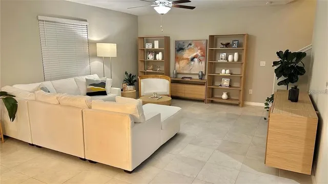 a living room with furniture and a lamp