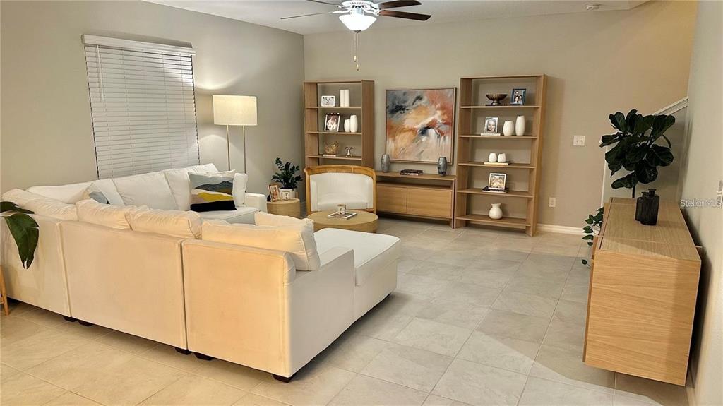 31363 Sun Kettle Loop Wesley Chapel, FL 33545 - Photo 11 of 29 a living room with furniture and a lamp