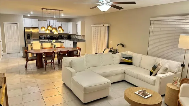 a living room with furniture and a chandelier
