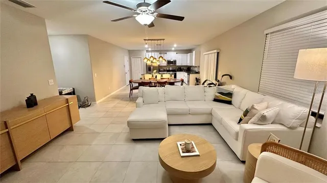 a living room with furniture and a chandelier