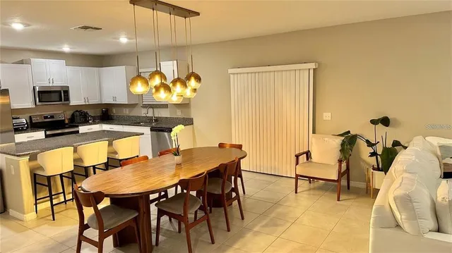 a kitchen with a table and chairs in it