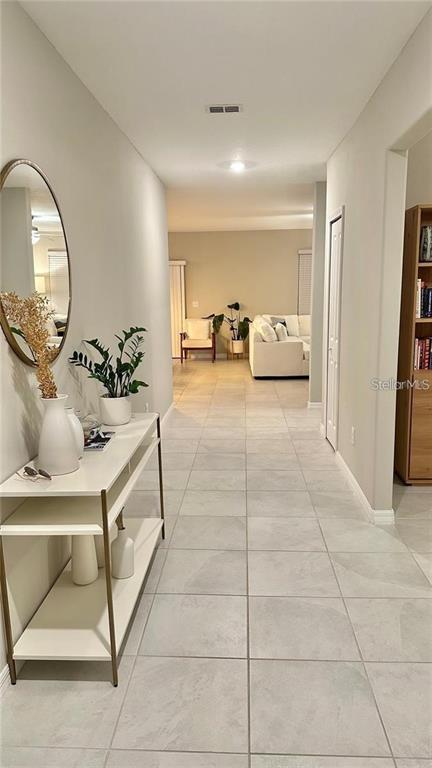 31363 Sun Kettle Loop Wesley Chapel, FL 33545 - Photo 7 of 29 a spacious bedroom with a bed and a mirror