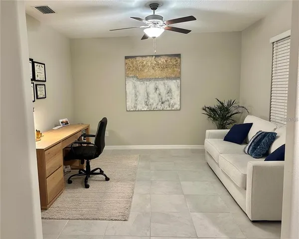 a living room with furniture and a piano