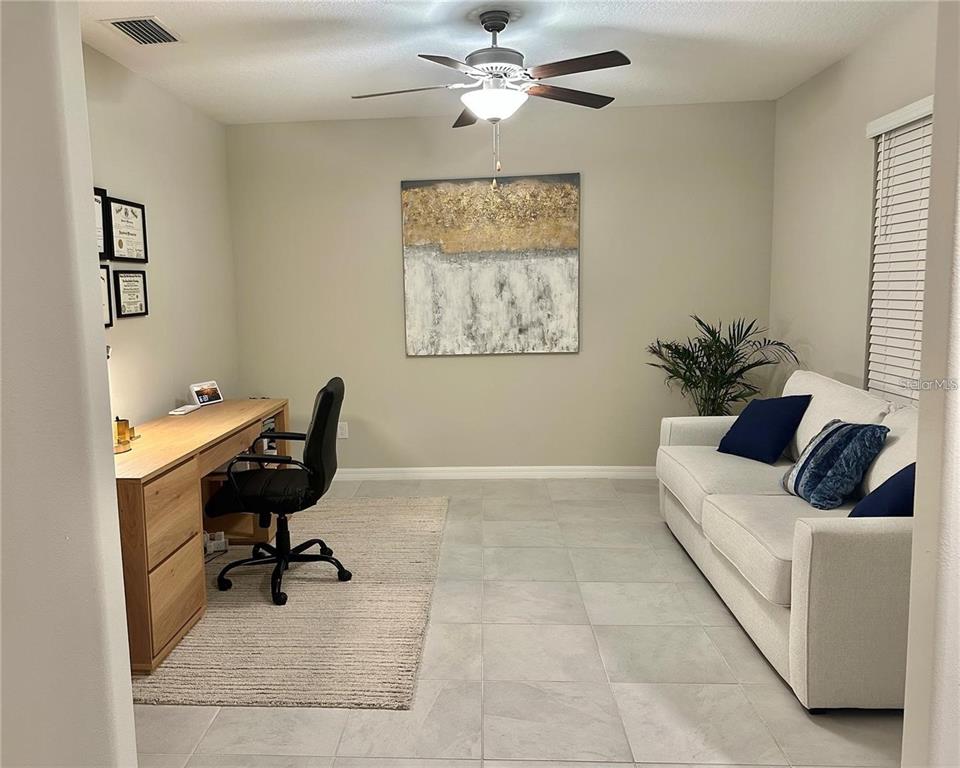 31363 Sun Kettle Loop Wesley Chapel, FL 33545 - Photo 9 of 29 a living room with furniture and a piano