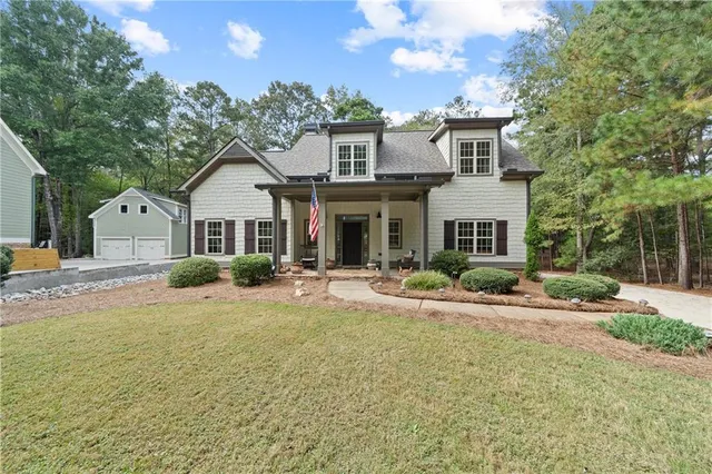 a view of a house with backyard and sitting area