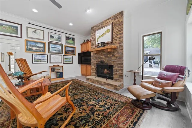 a view of an empty room with a window and a kitchen
