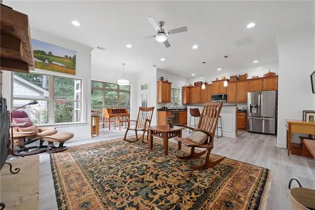 a view of a hallway with wooden floor and furniture