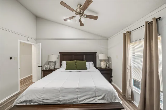 a bed sitting in a bedroom next to a window