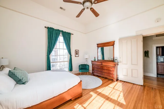 a view of a patio with table and chairs with wooden floor and fence