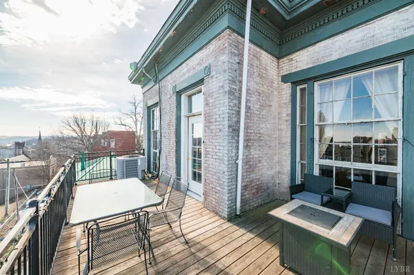 a view of a city from a balcony with furniture