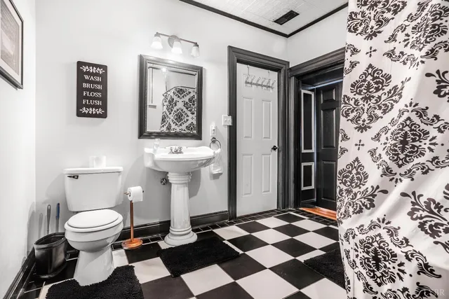 a living room with furniture a flat screen tv and a wall painting