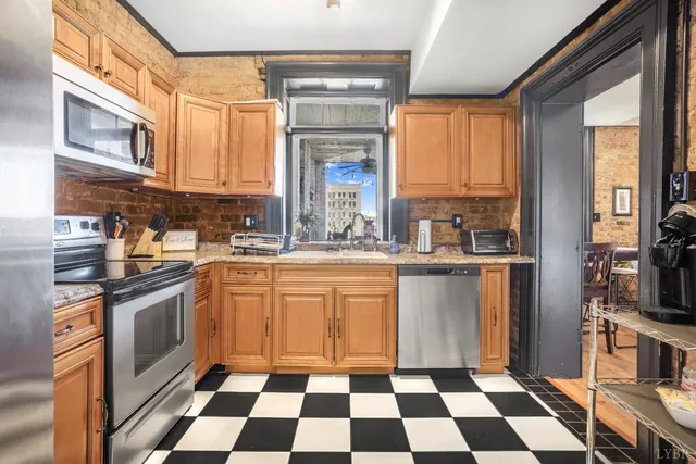 a view of a dining room with furniture and a chandelier