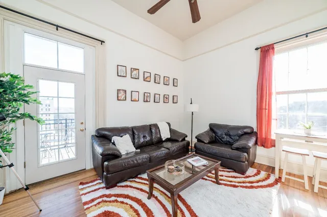 a living room with furniture and a potted plant