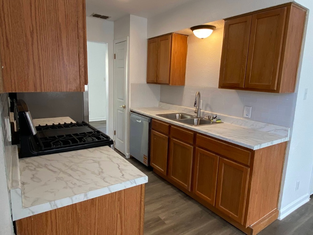 5813 Signal Point Austin, TX 78724 - Photo 2 of 12 a kitchen with a sink and a stove top oven